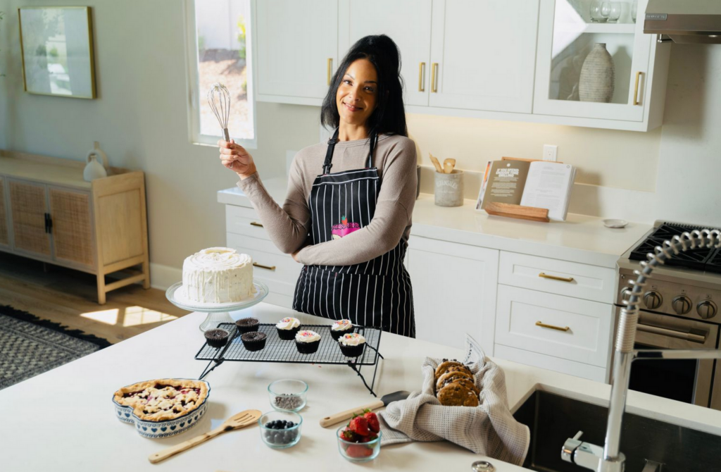 Chef Andrea baking in her kitchen, surrounded by sweets.